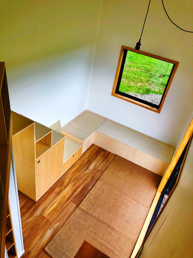 Tiny Home Storage Stairs and Couch Area