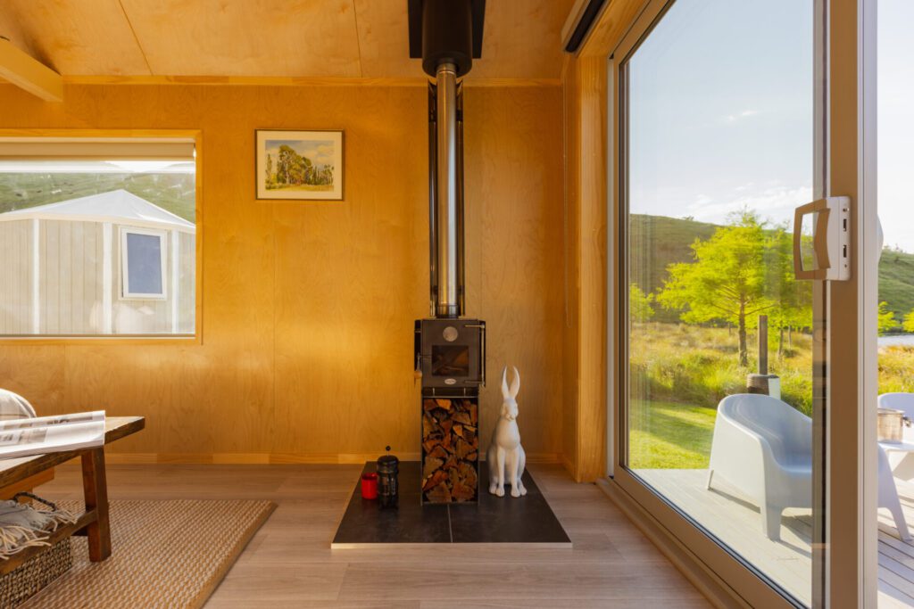 Inside the Everest Cabin by Fox Cabins showing Mini Meg Woodburning Fireplace