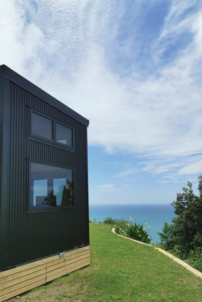 Tasman XL by Fox Cabins clad in Thermory Nordic Pine and Flax Pod Coloursteel